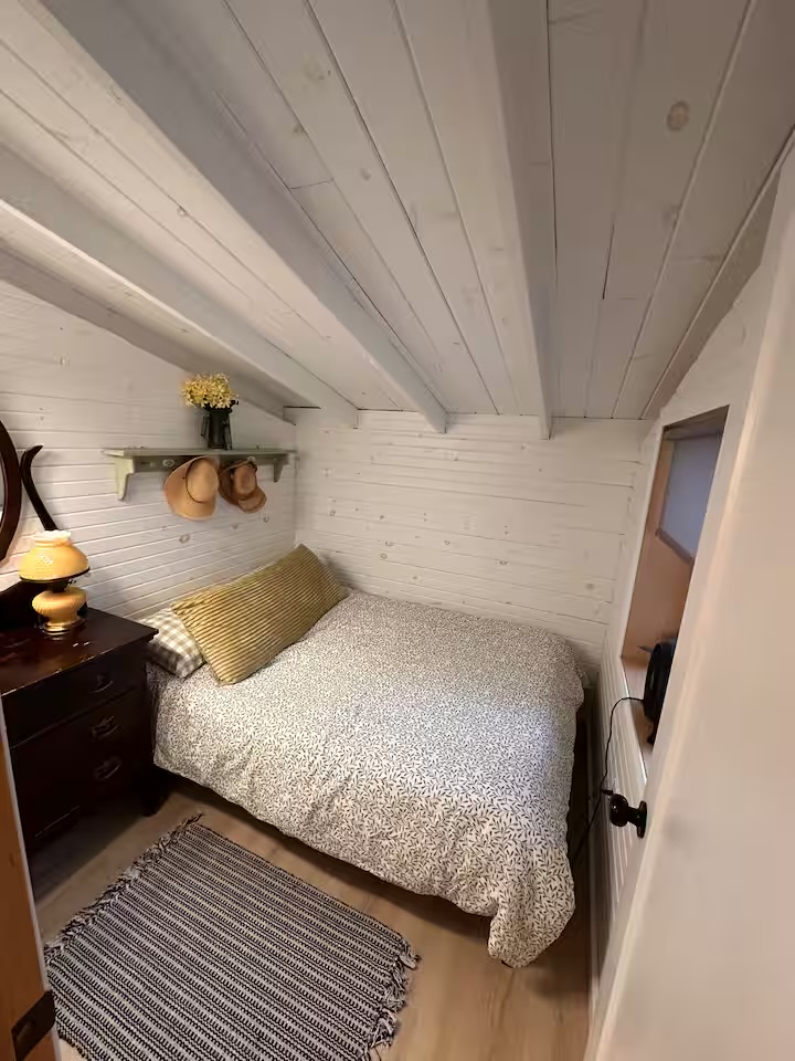 Small restful double bedroom with reading lamp
