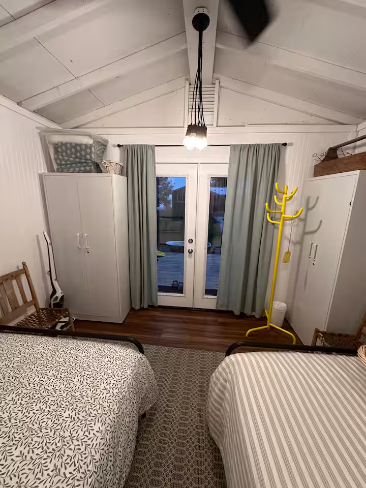 Bunky bedroom with two double beds and garden doors