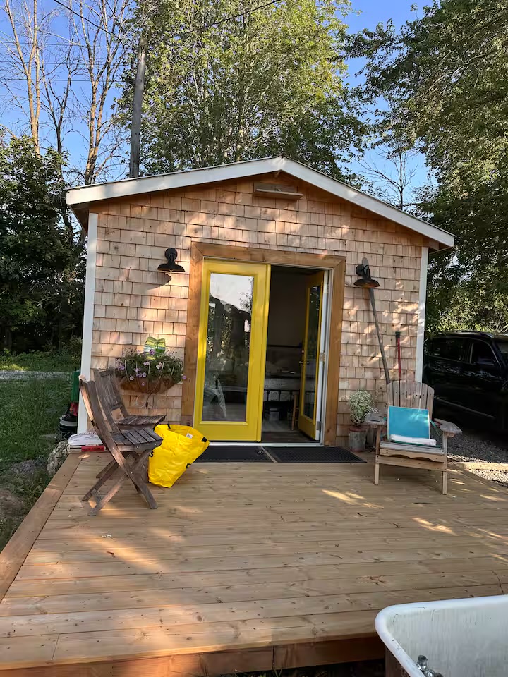 Separate bunky with yellow doors and a private deck