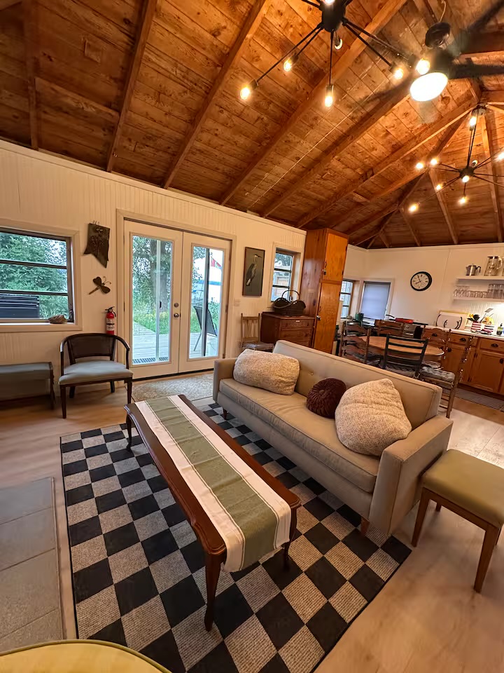 Comfortable cottage living room with exposed wood ceiling